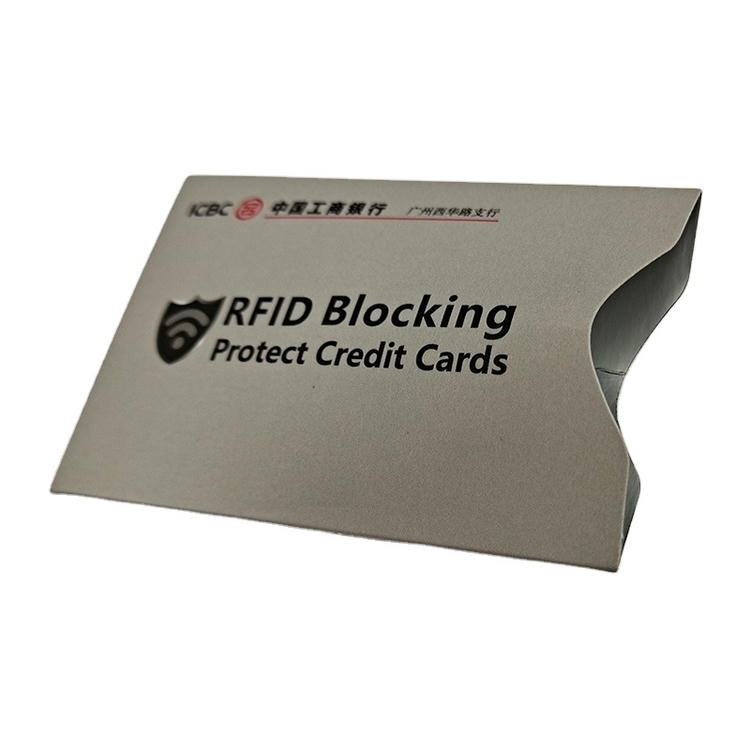 Siva bankarska poklon kutija sa logom banke za RFID zaštitne futrole pripremljene za distribuciju u okviru za bezbednost kartica u putnim novčanicima.
